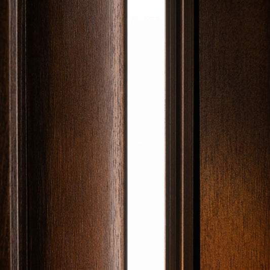 Close-up view of a ultra-discreet, 10mm x 9mm flush-mount white LED accent light integrated perfectly between premium dark wood acoustic paneling with no bulky trim.