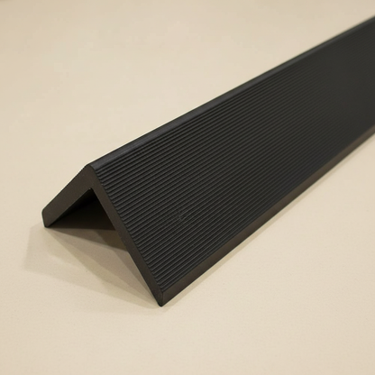 Black L-shaped corner trim profile for protecting edges and finishing architectural wall cladding.