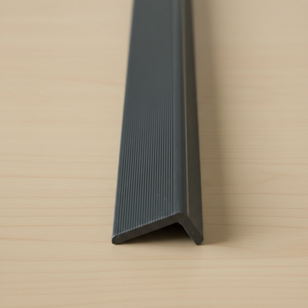 Detailed close-up of a Black minimalist composite edge trim, highlighting the textured surface and 15mm x 25mm profile for precise cladding finishes.