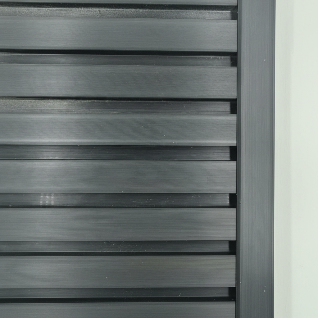 A sleek black architectural trim providing a seamless edge finish to a modern slat wall installation.