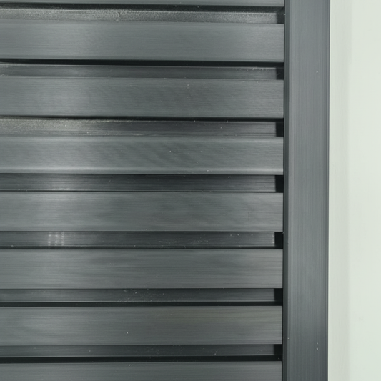 A sleek black architectural trim providing a seamless edge finish to a modern slat wall installation.