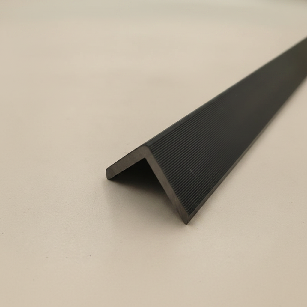 Detailed high-angle shot of a black architectural trim highlighting its durable surface and minimalist design.