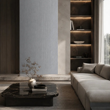 Premium dark grey oak wood-effect SPC feature wall cladding installed seamlessly in an elegant architectural lounge setting behind a luxury marble coffee table and modern couch.