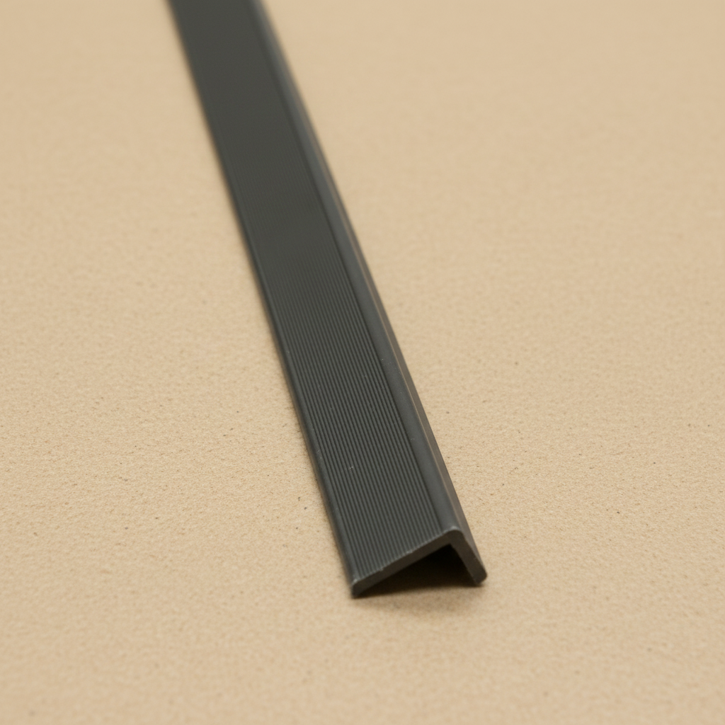 Detailed high-angle view of the Grey composite edge trim's textured surface, designed for long-lasting UV resistance and outdoor wall cladding protection.