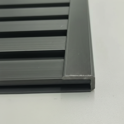 A seamless installation of a Grey architectural trim providing a professional edge finish to a matching horizontal slat wall panel.