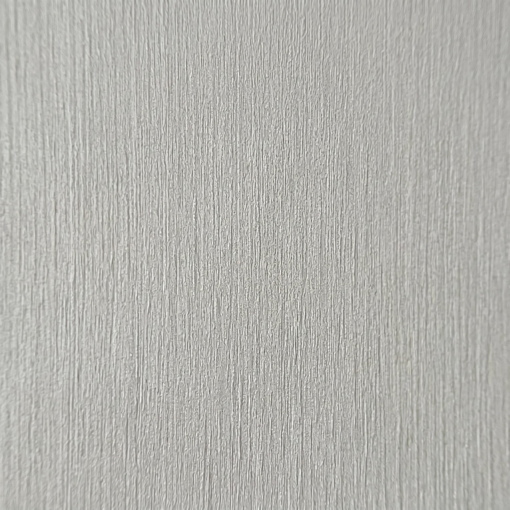 High-resolution macro zoom demonstrating the realistic architectural wood grain texture on the decorative finish of a grey premium SPC wall board.