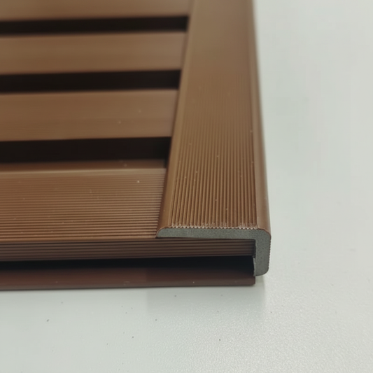 A seamless installation of a Light Brown architectural trim providing a clean and professional edge finish to matching horizontal slat wall panels.