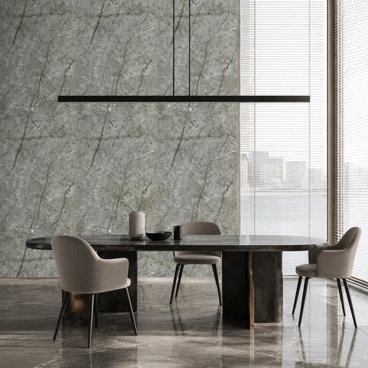 Luxury dining room interior featuring full-height gold and grey marble PVC wall cladding panels behind a modern black dining table setup with large windows.