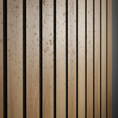 Close-up texture of waterproof oak wood grain PVC slat panel with water droplets, demonstrating moisture resistance for bathroom and shower walls.