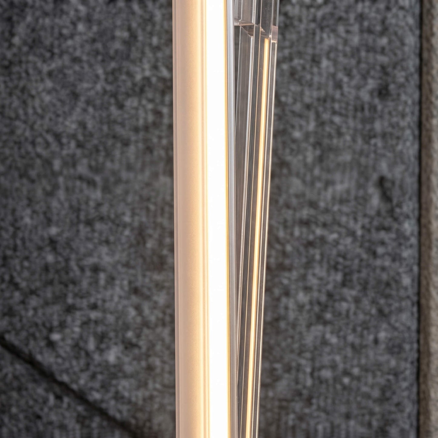 Macro view of a high-end black architectural LED strip housing with a custom frosted diffusion lens designed to prevent hot spotting on luxury interior accent walls.