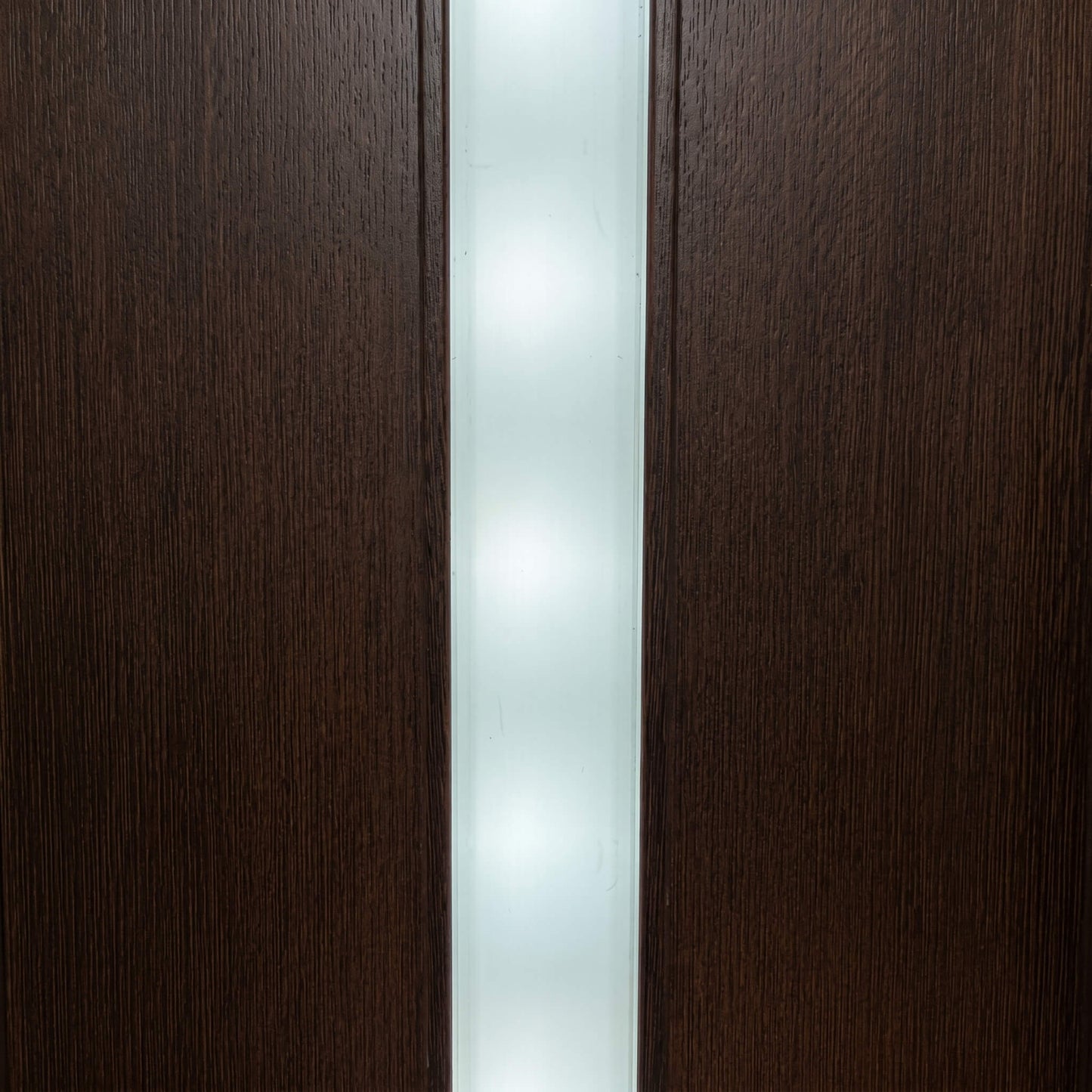 Seamless dot-free modern white LED light strip glowing elegantly inside a dark timber slat wall groove, showcasing the hidden visibility aesthetic.